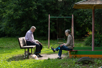 two old people, an elderly couple on a walk with a dog, sad depressive mood of elderly people, fatigue from life