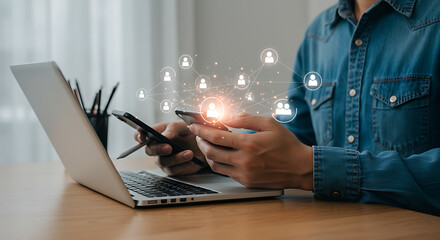 Man using smartphone and laptop with glowing network of people icons connecting them, symbolizing social media and global communication