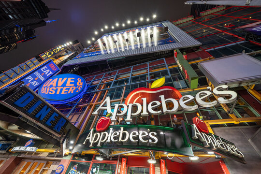 New York City - June 14, 2025: Night view of Applebee&rsquo;s storefront glowing with illuminated signage and welcoming entrance