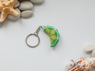 Decorative green floral key chain accessory on a chain