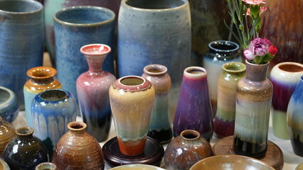 Colorful handcrafted ceramic vases on display at a Taiwan local market. A vibrant and artistic...