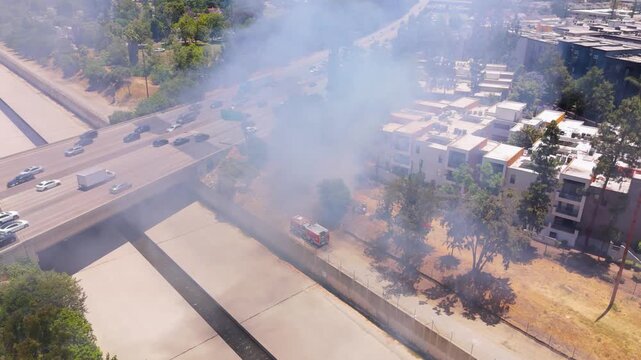 Fire truck responds to wildfire near highway in Los Angeles