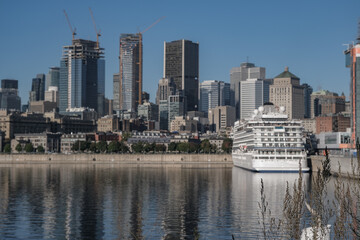 Obraz premium All inclusive luxury yacht cruiseship cruise ship liner Star docked in port St. Lawrence River in Montreal, Quebec Canada during New England Indian Summer cruising