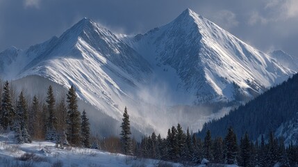 Snowy peaks, evergreen trees, blue sky, and valley in a mountain landscape