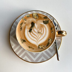 cup of coffee with gold