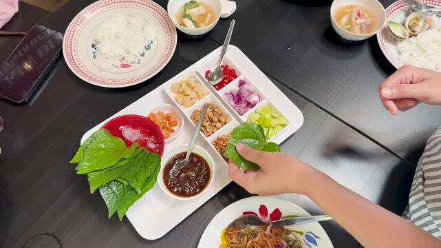 Preparing Miang Kham Savory Leaf Wraps at Dining Table