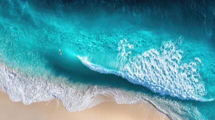 Fototapeta premium Turquoise water waves meeting sandy beach.
