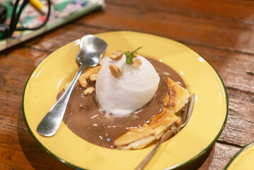 Delicious dessert with chocolate sauce and ice cream