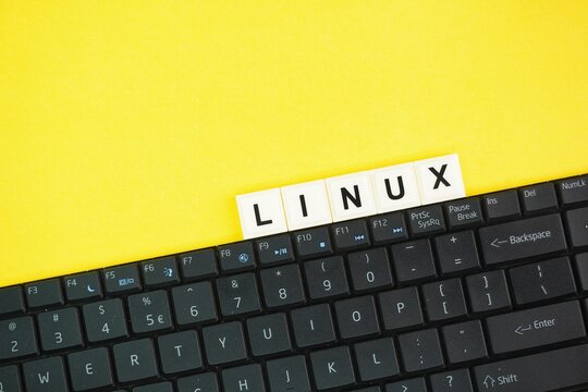 letters of the alphabet with the word linux and yellow background. Internet concept. Linux is a family of open-source Unix-like operating systems based