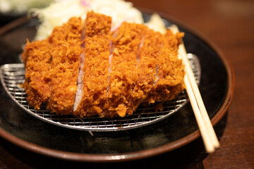 Crispy Japanese Pork Cutlet Tonkatsu on Black Plate