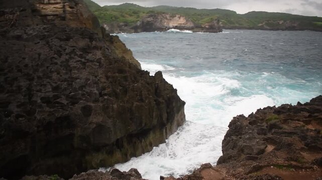 strong waves crashing against the rocks