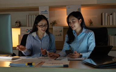 Teamwork in Action. Two women collaborating on business strategies in an office.