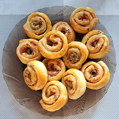 Savory puff pastry pinwheels with ham, cheese and olives – top view