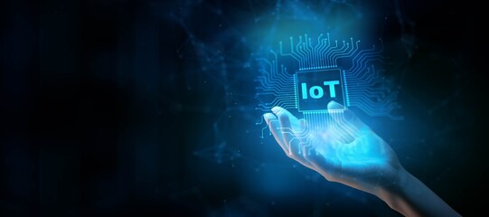 IoT Internet of Things Concept: Connecting Devices for Smarter Living Illustrated on a Processor Touched by a Human Hand.