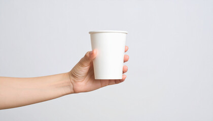 Woman's Hand Holding a Blank White Paper Cup on a White Background