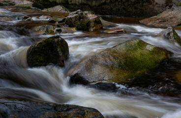 mountain river flowing water moss on stone blurred water