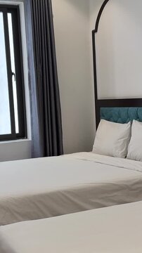 hotel room for four people adult woman comes examines bed sits down looks out dirty window cheap hotel uncomfortable. High quality 4k footage