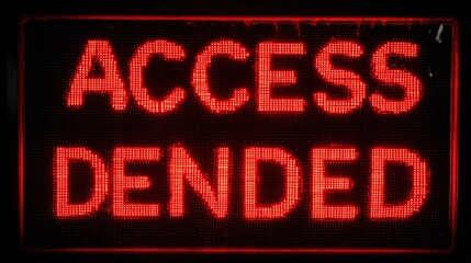 Access Denied: A digital display emphatically proclaims 'ACCESS DENIED' in a bold, red, pixelated font, conveying a clear message of restriction and prohibition.