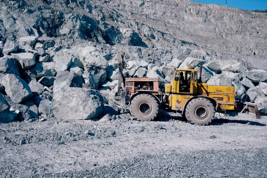 K-700 Kirovets tractor with attached scraper and hydraulic hamme