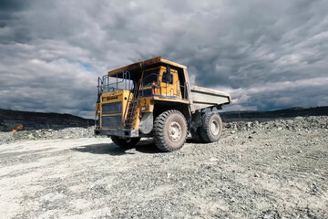 mining dump truck against the background of a quarry and a sky w © Olga
