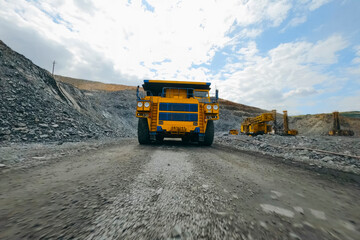 Yellow Big Mining, Dump Truck Driving in Quarry Road © Olga