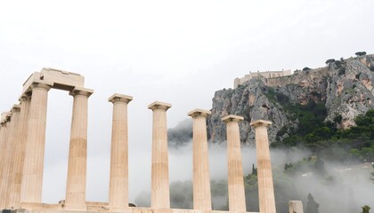Fototapeta premium Ancient Greek Temple Columns with Acropolis in Misty Background