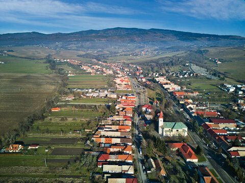 Aerial view of the town's neat rows of houses and the church with its white steeple nestled amongst the trees, Detva, Bansk&Atilde;&iexcl; Bystrica Region, Slovakia.