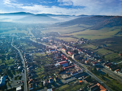 Aerial view of the town nestles amidst a scenic valley, with the distant mountains casting long shadows over the landscape, Detva, Bansk&Atilde;&iexcl; Bystrica Region, Slovakia.