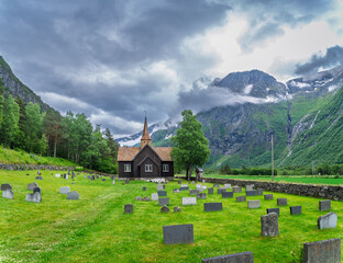 Fototapeta premium small church surrounded by graves