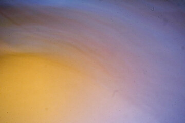 Abstract yellow and blue shades blurred background with soft lines of orange and brown blending together creating a smooth flowing and dreamy visual effect for modern and artistic design