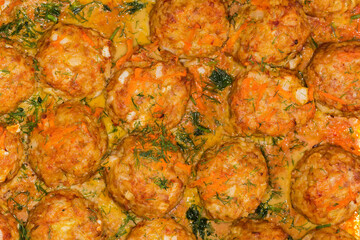 Rice meatballs stewed with red sauce, top view close-up