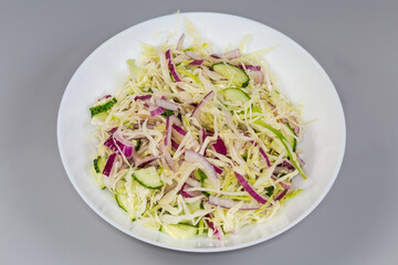 Salad of sliced fresh vegetables on the white dish