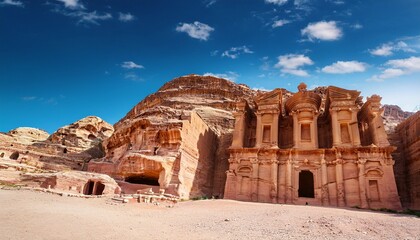 ancient rock carved structures of petra under a bright blue sky historic archaeological site desert landscape