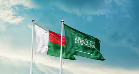 Madagascar  and Saudi Arabia friendship flags are waving in the sky. Two country flag for agreement or deal. Madagascar KSA national flag for commitment.