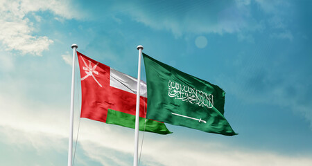 Oman and Saudi Arabia friendship flags are waving in the sky. Two country flag for agreement or deal. Oman KSA national flag for commitment.
