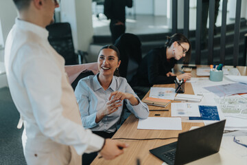 Group of business employees engaging in a collaborative discussion while working on a project in a contemporary office setting. The atmosphere is productive and focused.