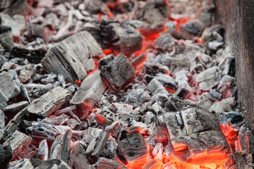 Photo of hot coals. texture of coals on the grill. Edge in the grill