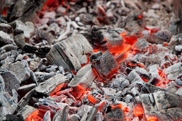 Photo of hot coals. texture of coals on the grill. Edge in the grill