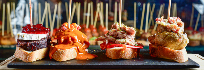 Gourmet delicacies, assorted pinchos on a slate plate