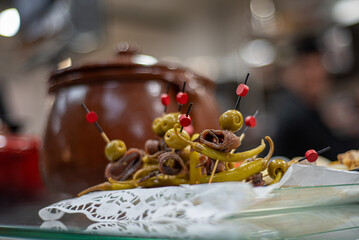 Savory snack, anchovy and olive in a traditional appetizer
