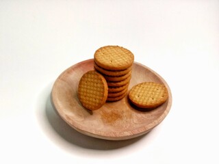 Round crunchy biscuits arranged on a plate, perfect for snack, breakfast, or tea time. Tasty cookies with golden brown texture, ideal for food, bakery, and dessert concepts.