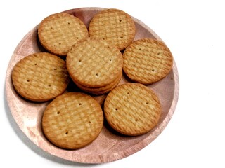 Round crunchy biscuits arranged on a plate, perfect for snack, breakfast, or tea time. Tasty cookies with golden brown texture, ideal for food, bakery, and dessert concepts.