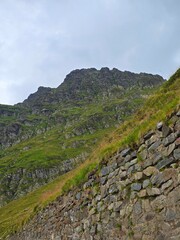 Fagaras Mountain peak seen from the Transfagarasan Road on a cloudy summer day. Sibiu, Romania