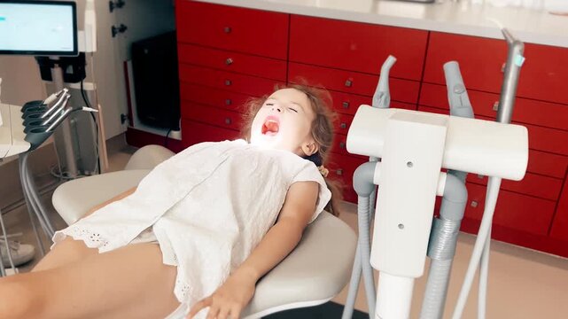 Little girl at dentist chair during dental examination