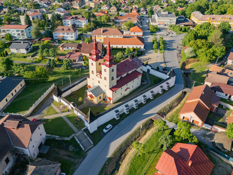 Aerial view of the Church of All Saints with its striking red-roofed towers standing prominently amidst the town's architecture, Div&Atilde;&shy;n, Bansk&Atilde;&iexcl; Bystrica Region, Slovakia.