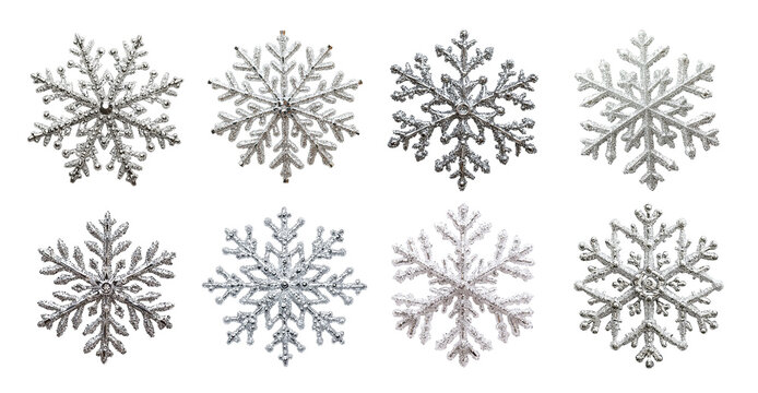 Glittering silver snowflakes isolated with intricate patterns. Each decorative flake features symmetrical winter-inspired shapes and frosty sparkle. Ideal for holiday designs, festive decor