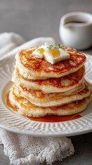 Fluffy pancakes stacked high with butter and syrup for a delightful breakfast experience