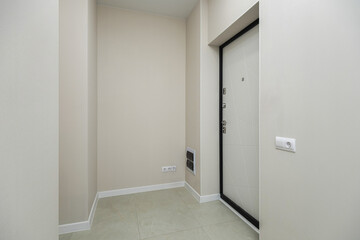 Modern entrance hallway with minimalist design and light decor in a residential building