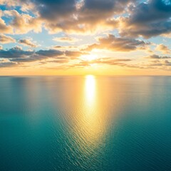 Obraz premium Serene Ocean Sunset With Golden Rays Reflecting on Teal Water
