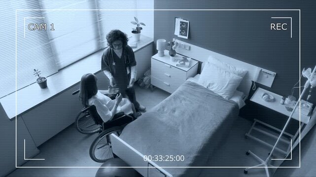 Wide top view of CCTV security camera filming female nurse transporting heavily pregnant woman in wheelchair to maternity ward in hospital, helping into bed while talking